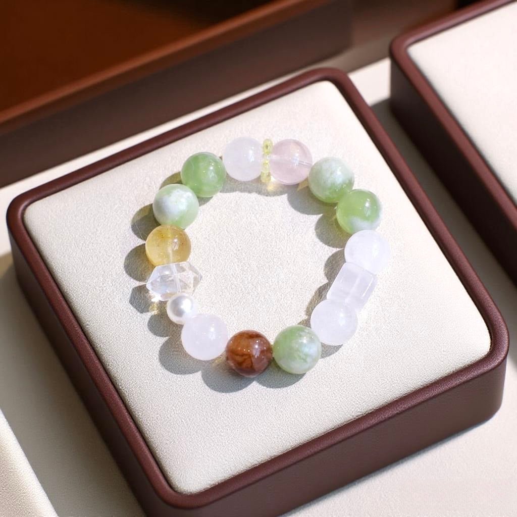 Natural crystal bracelet with Xiuyan Jade, White Phantom Quartz, Rose Quartz, Yellow Flower Agate, and Red Flower Agate.