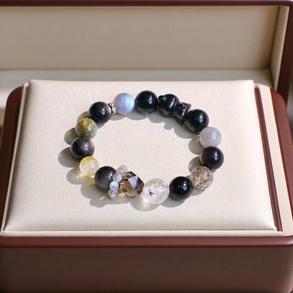 Natural crystal bracelet with Blue Tiger’s Eye, Silver Obsidian, and Blue Crystal beads.